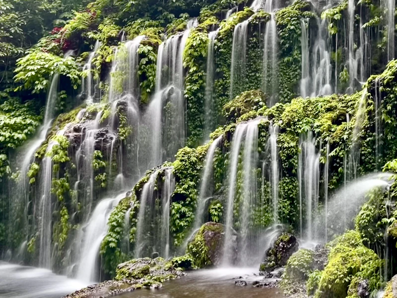 Banyumala Twin Waterfall pouring over a moss-covered cliff near Wanagiri, north Bali