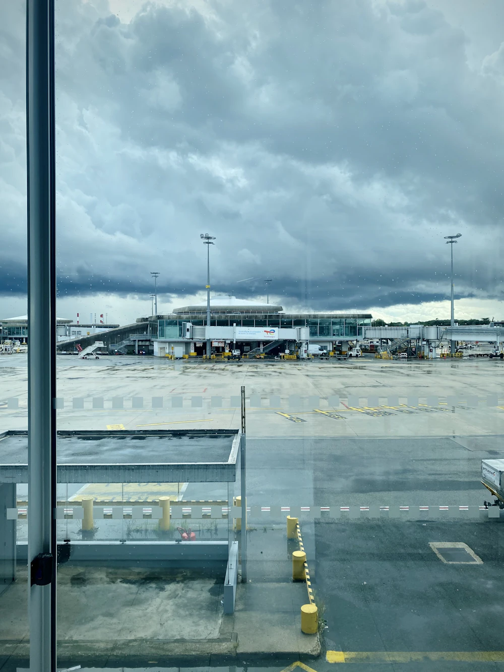 An aircraft on the tarmac, seen through an airport window.