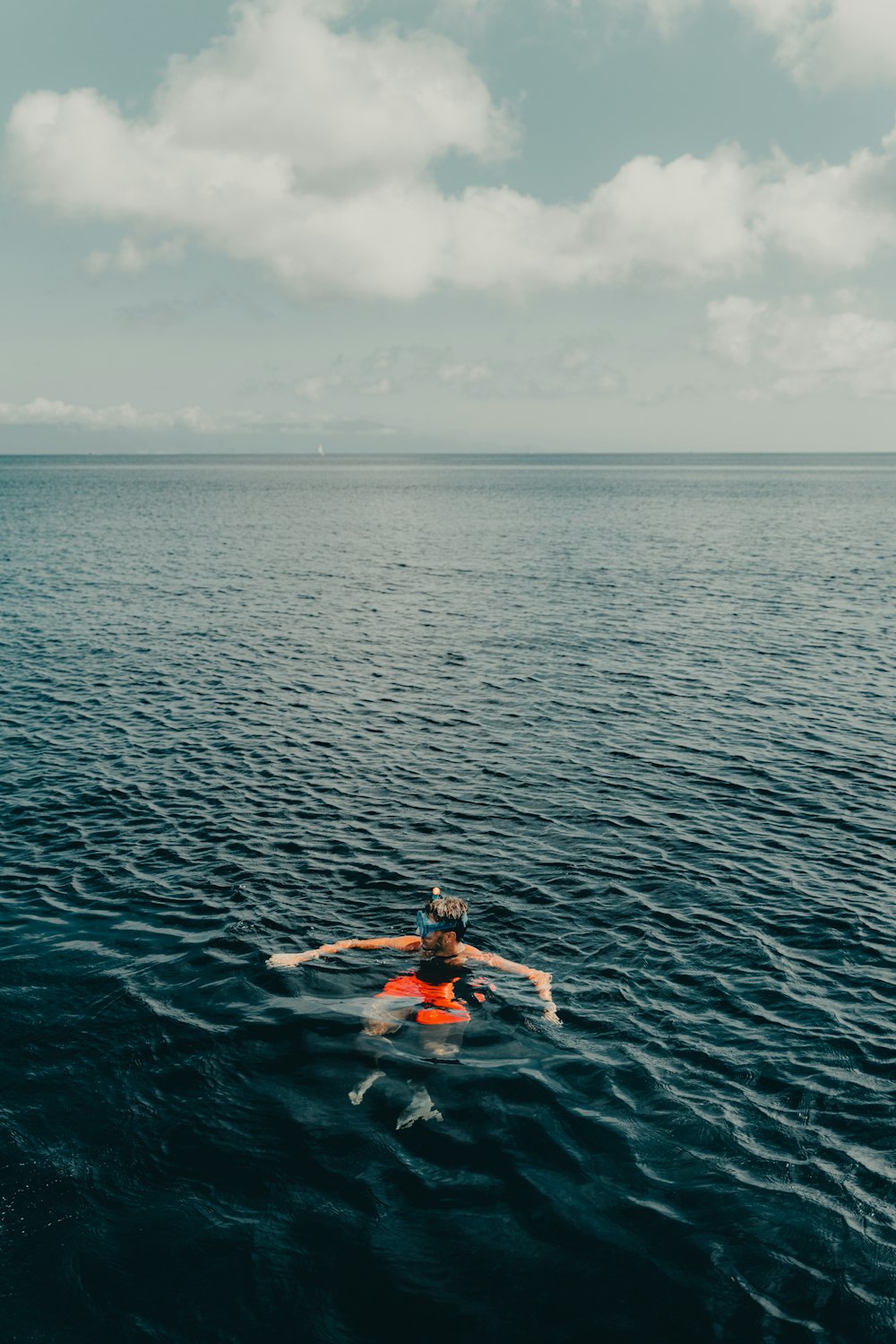 a person on a surfboard in the middle of the ocean