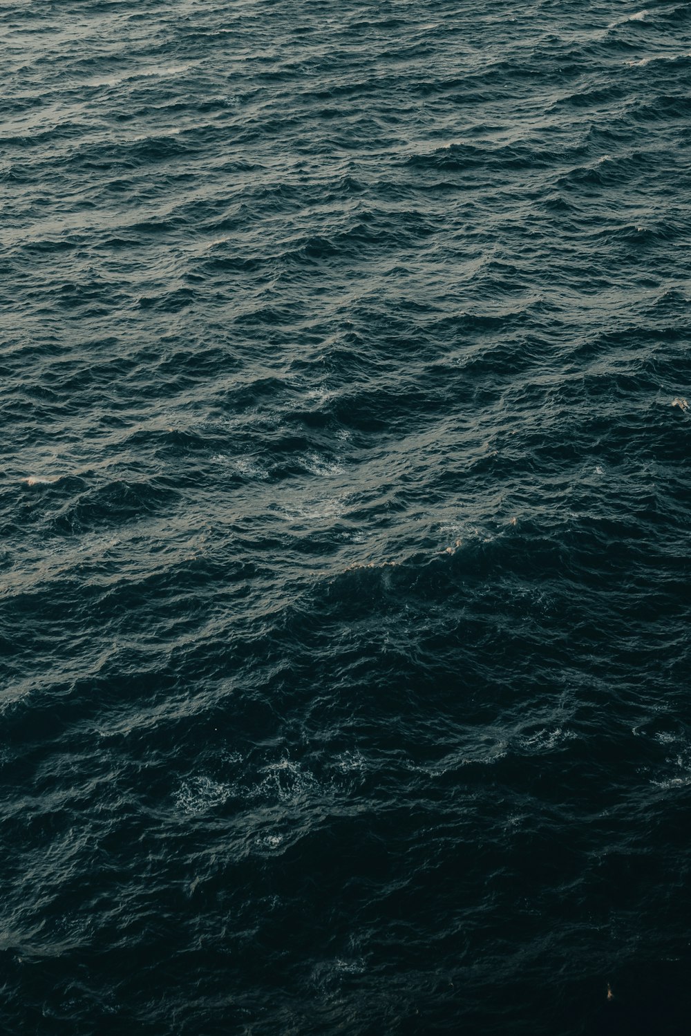 a large body of water with a boat in the distance