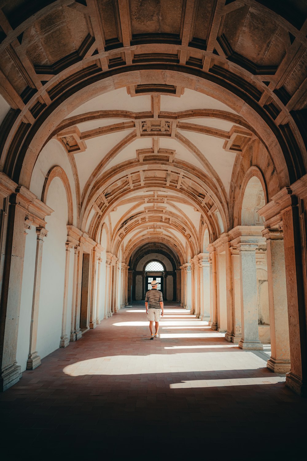 a person walking down a hallway in a building