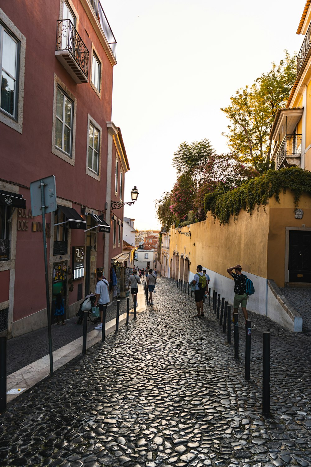 a group of people walking down a cobblestone street