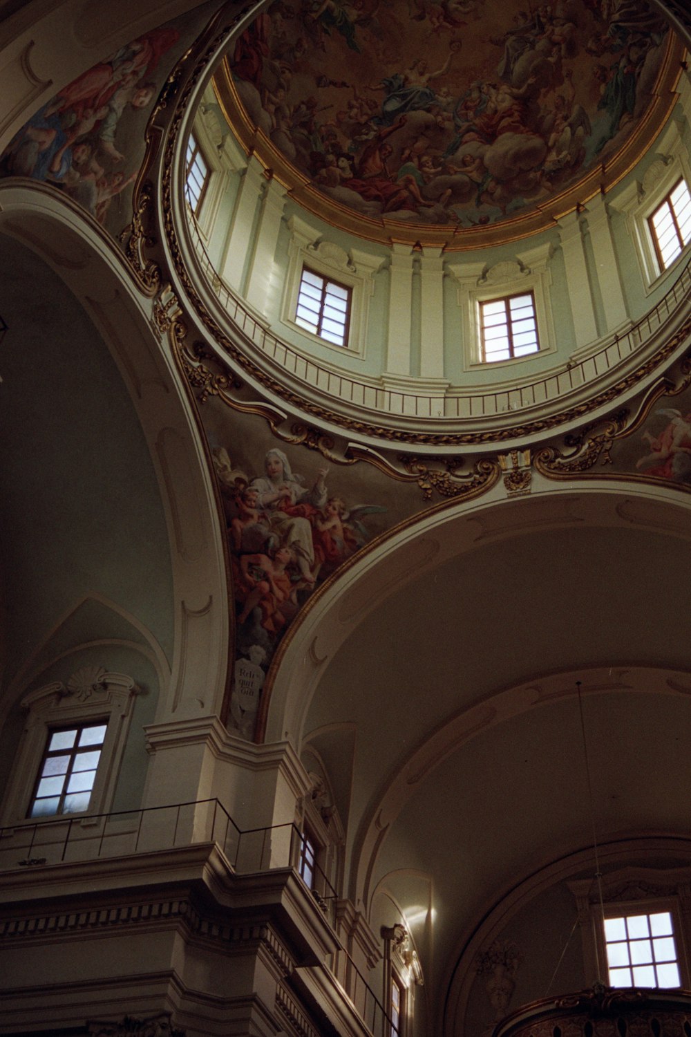 the ceiling of a large building with paintings on it