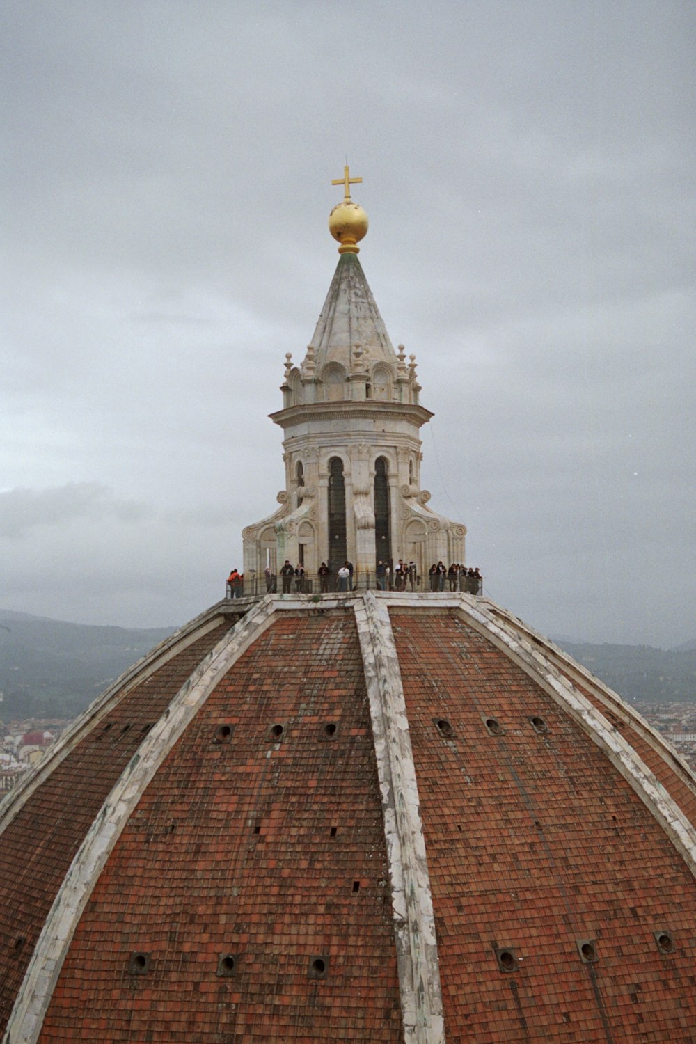 a large dome with a golden cross on top of it