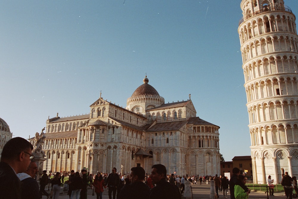 a group of people standing in front of a tall building