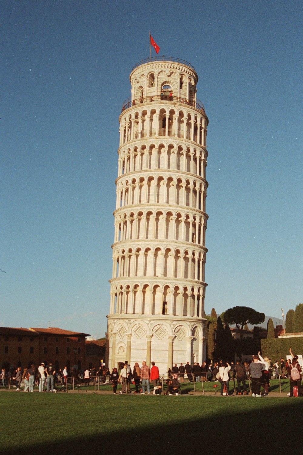 a very tall tower with a flag on top of it