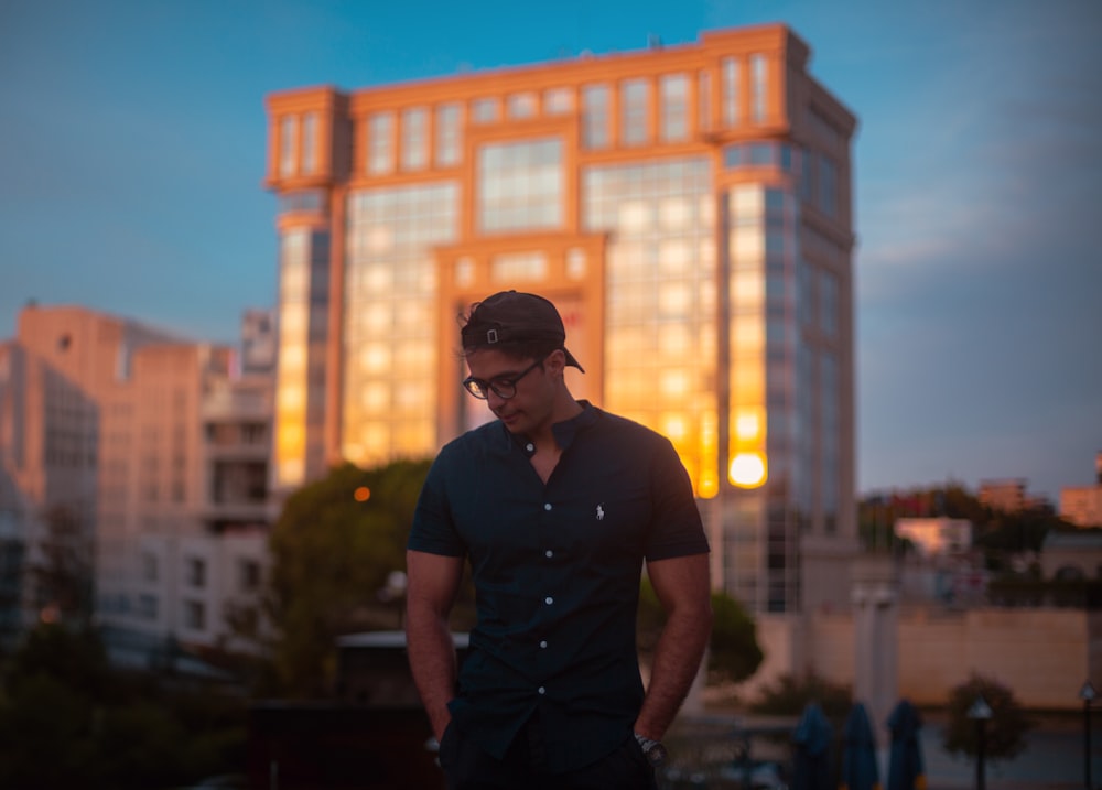 a man standing in front of a tall building