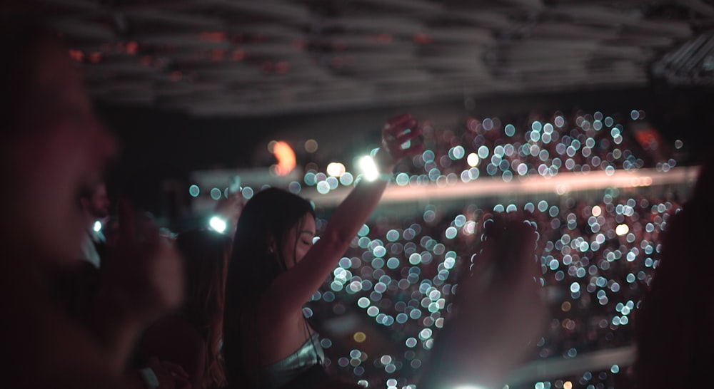 a group of people standing in front of a crowd at a concert