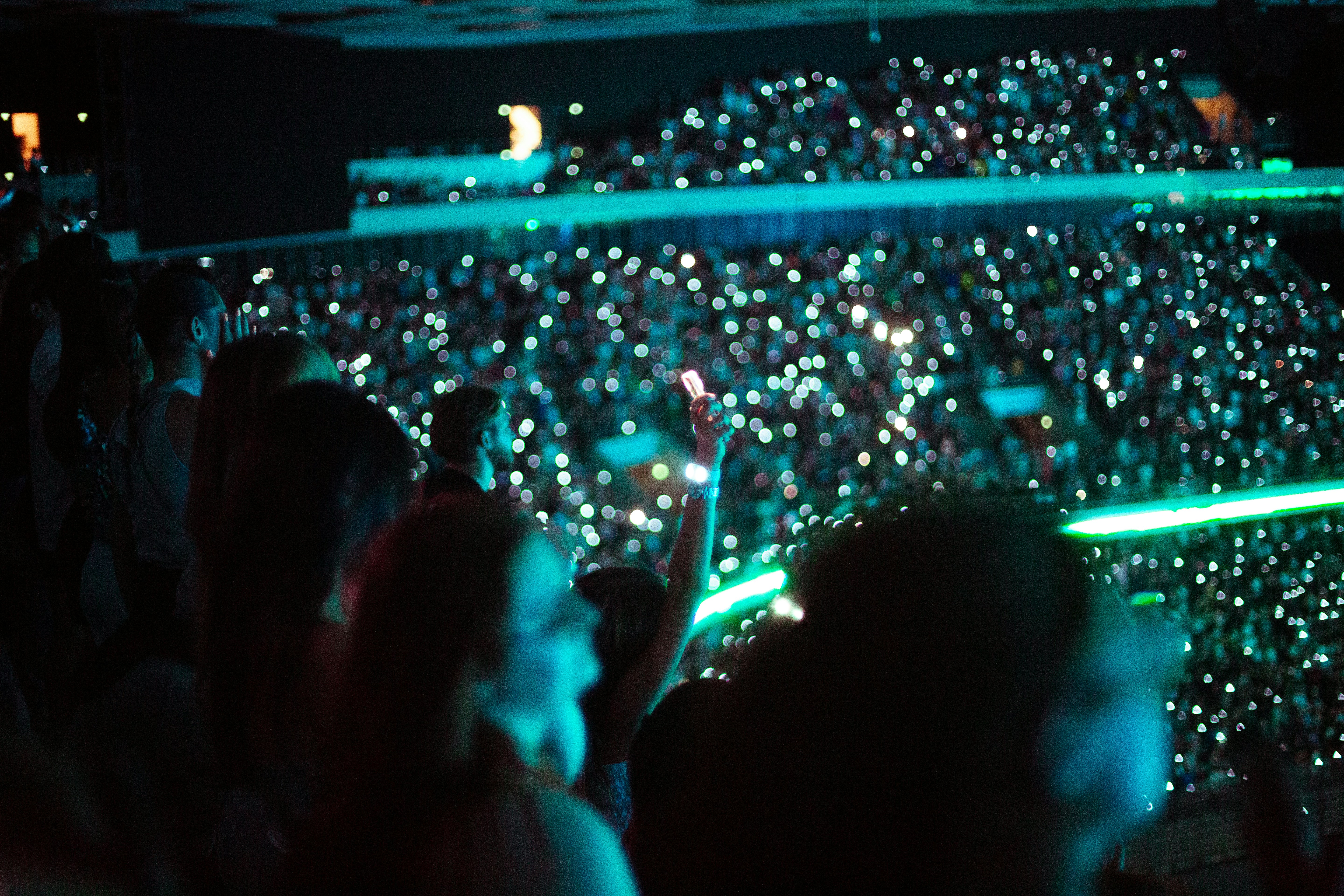a crowd of people standing in front of a stage