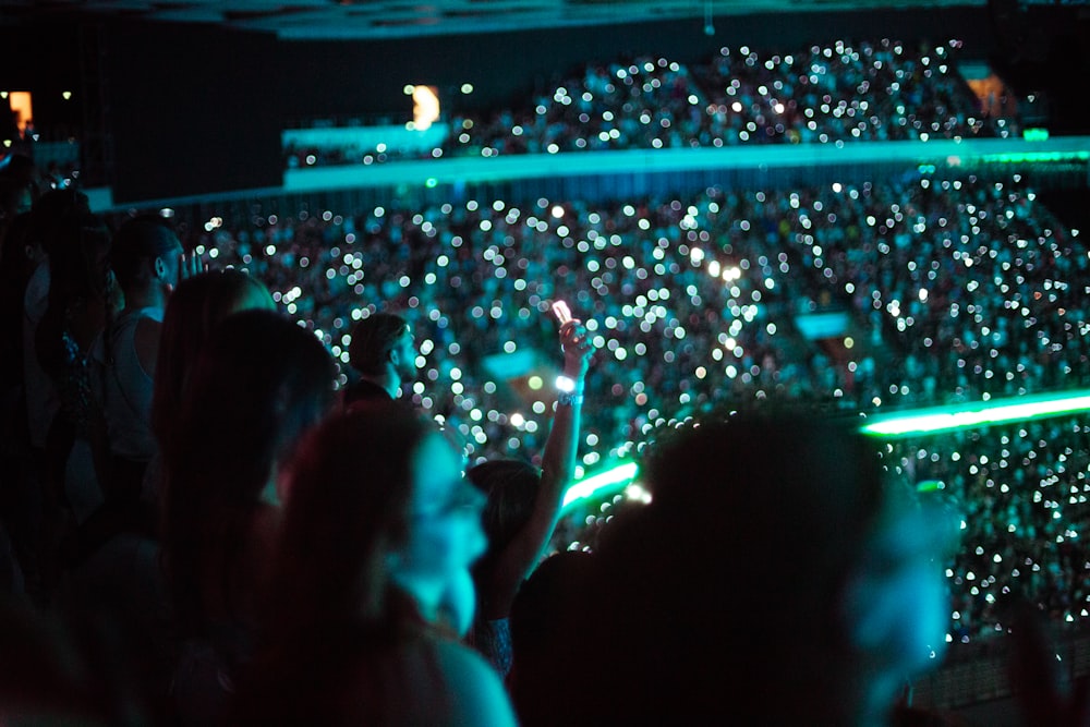 a crowd of people standing in front of a stage