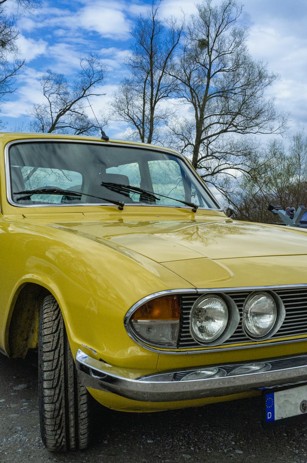 a yellow car parked in a parking lot