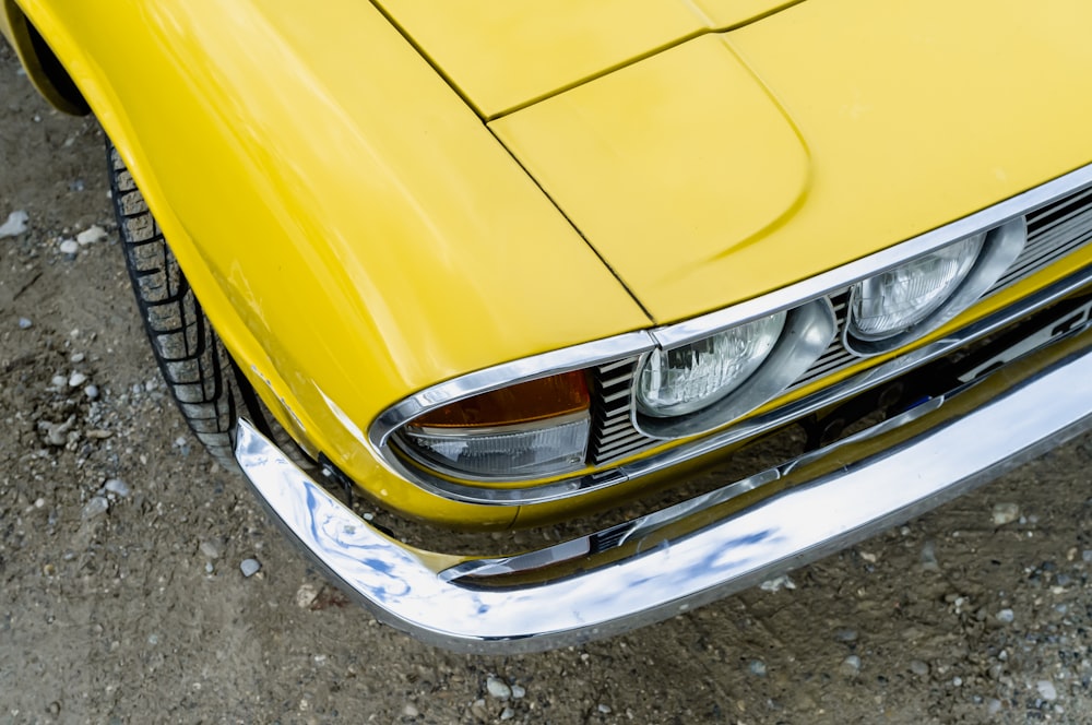 a close up of the front of a yellow car