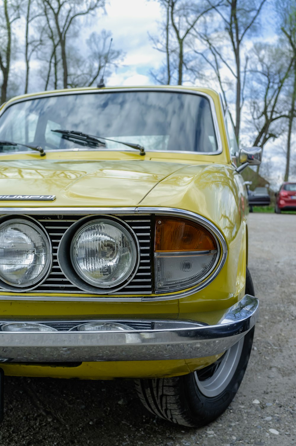 a yellow car parked in a parking lot