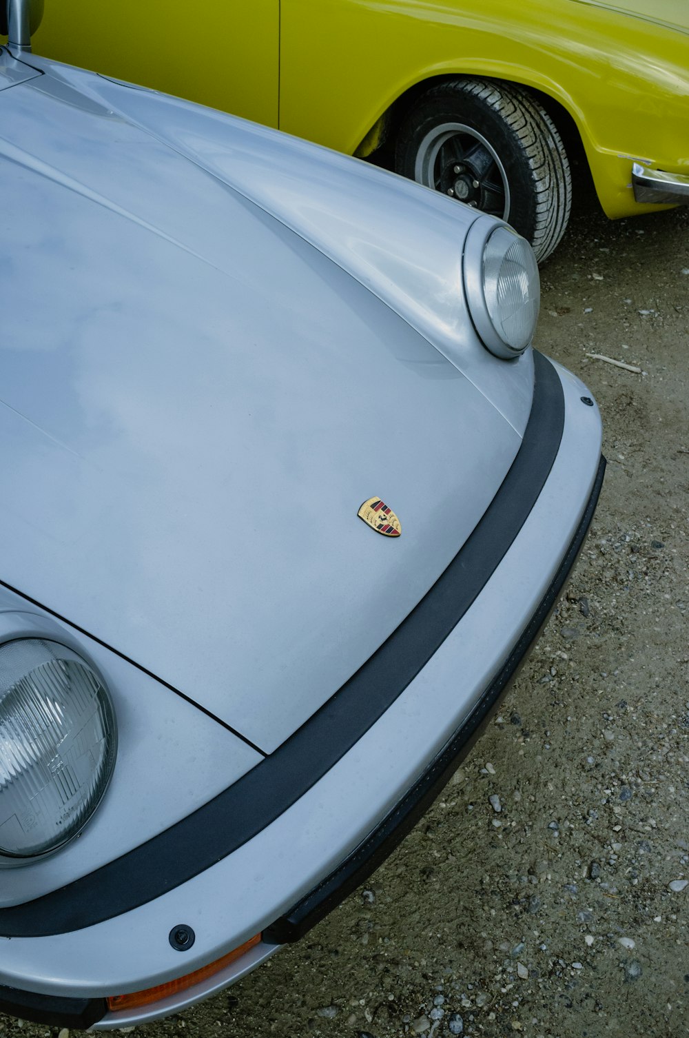 a yellow sports car parked next to a yellow sports car