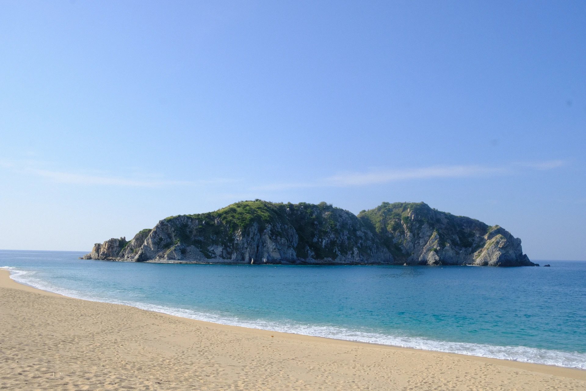a sandy beach next to a large body of water