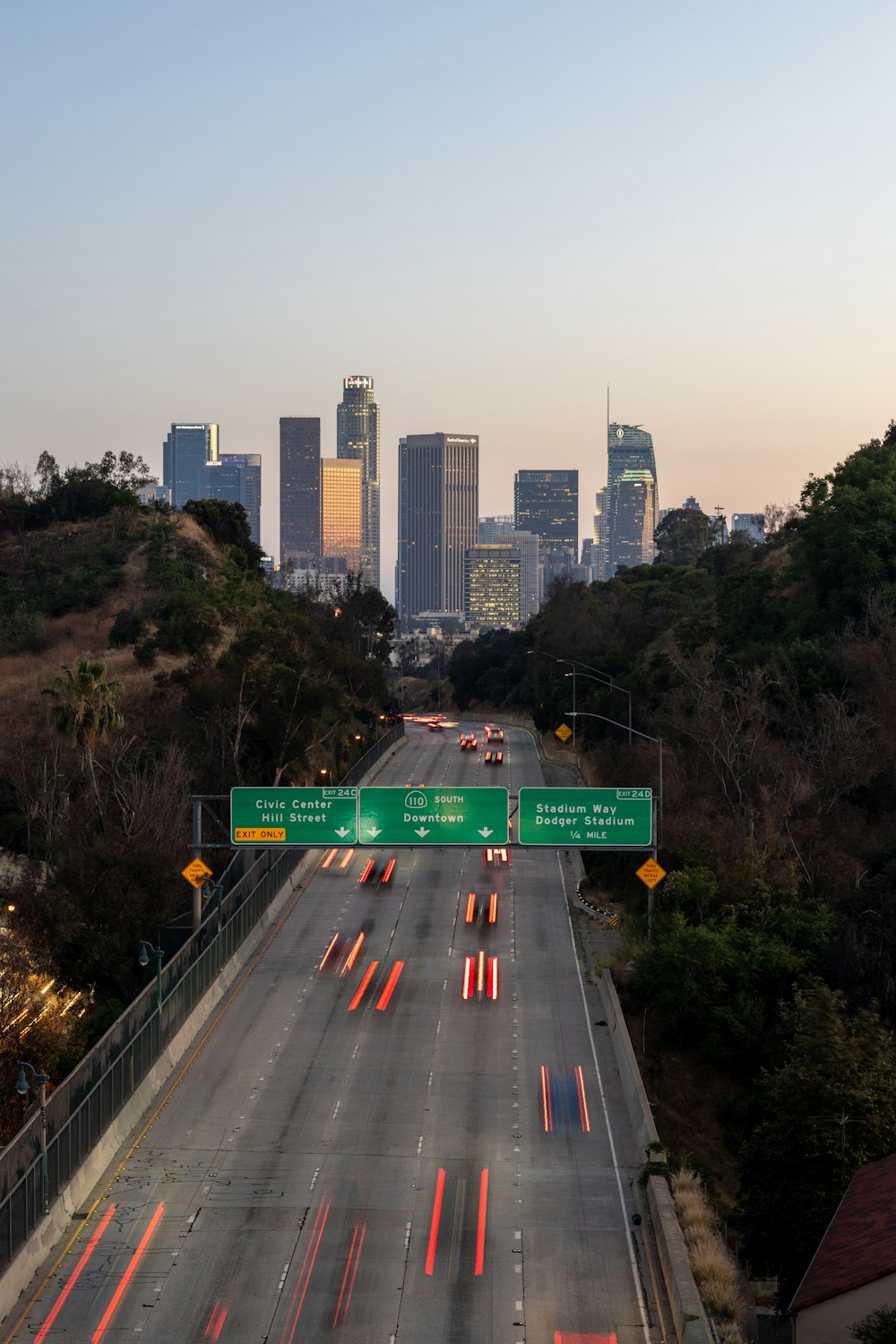 a freeway with a city skyline in the background