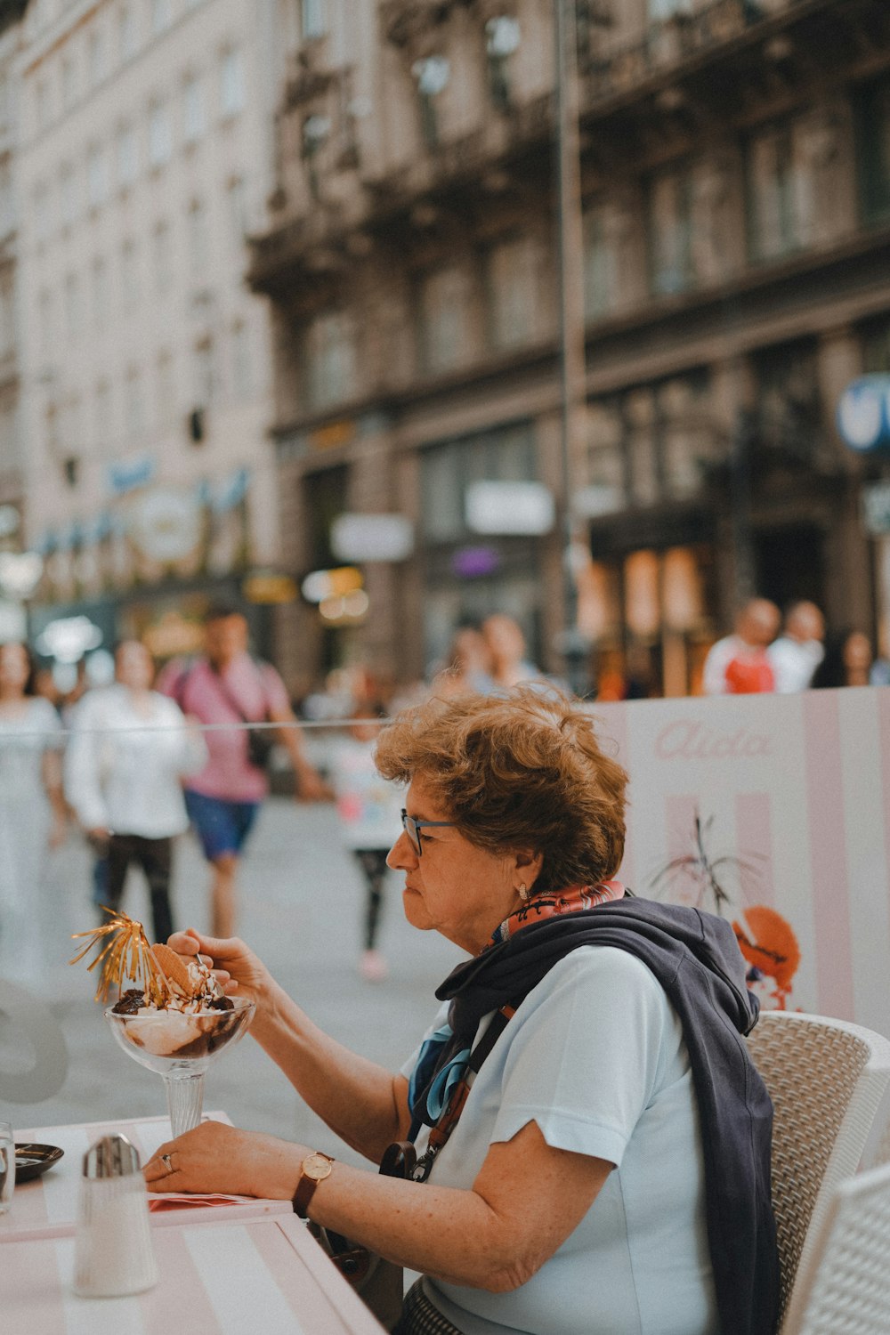 a woman sitting at a table eating food