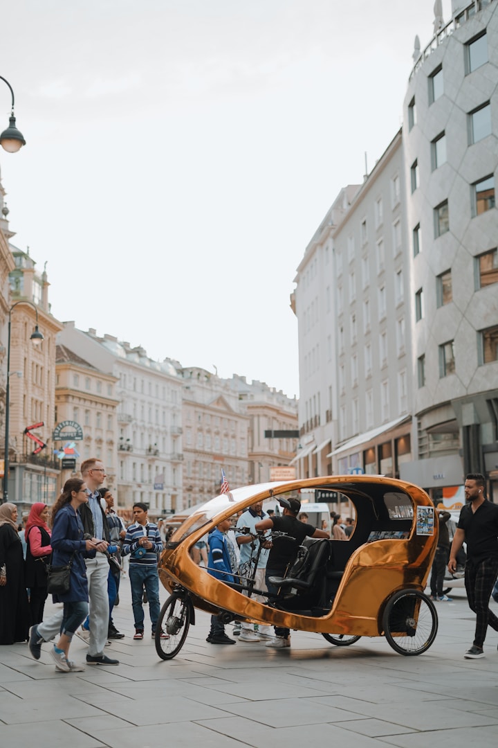 a group of people standing around a small car
