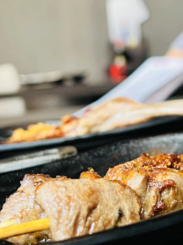 Close-up of sizzling Turkish kebabs grilled to perfection.