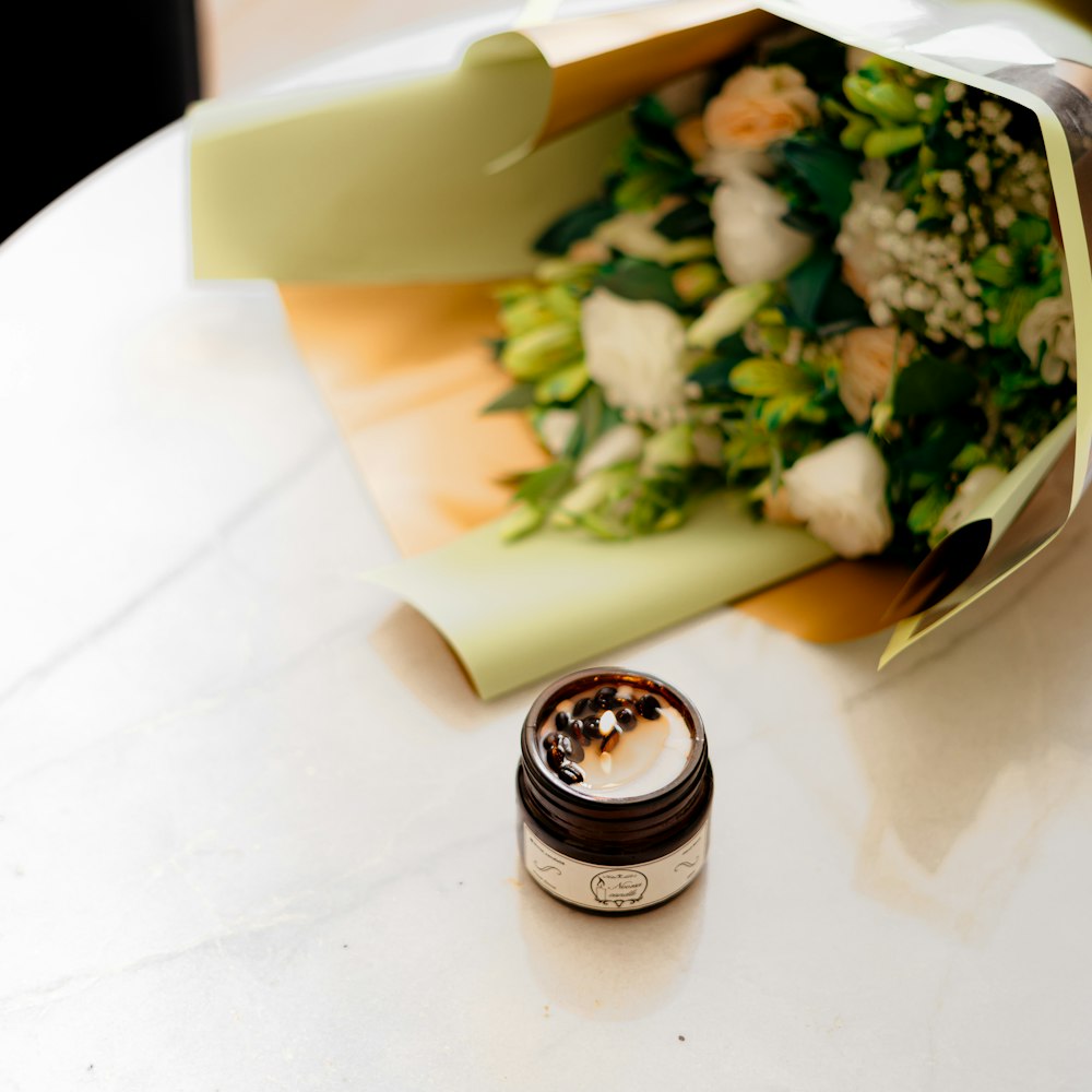 a bouquet of flowers and a wedding ring on a table