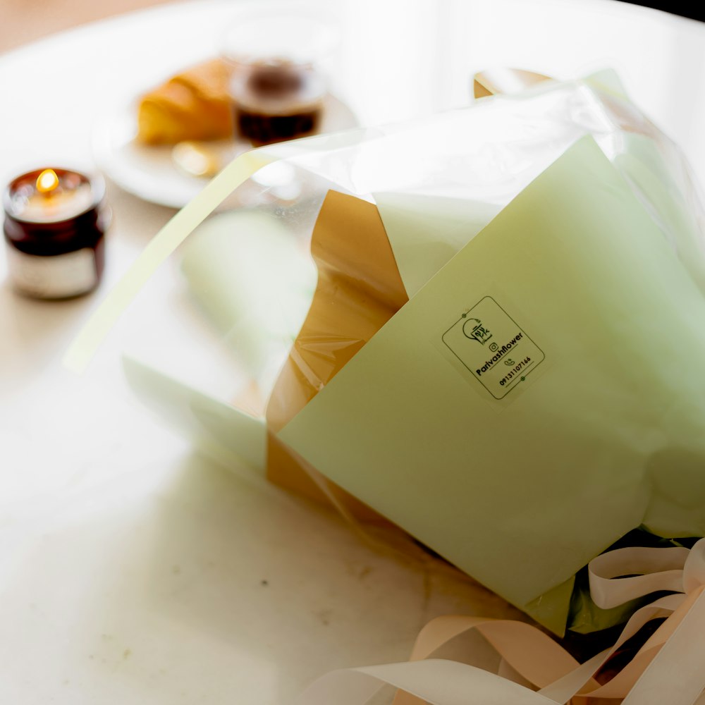 a white table topped with a bag of food