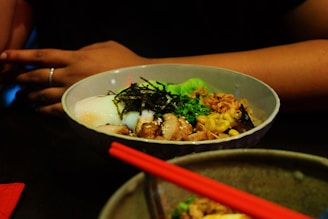 A vibrant bowl of Korean ramen with colorful toppings.