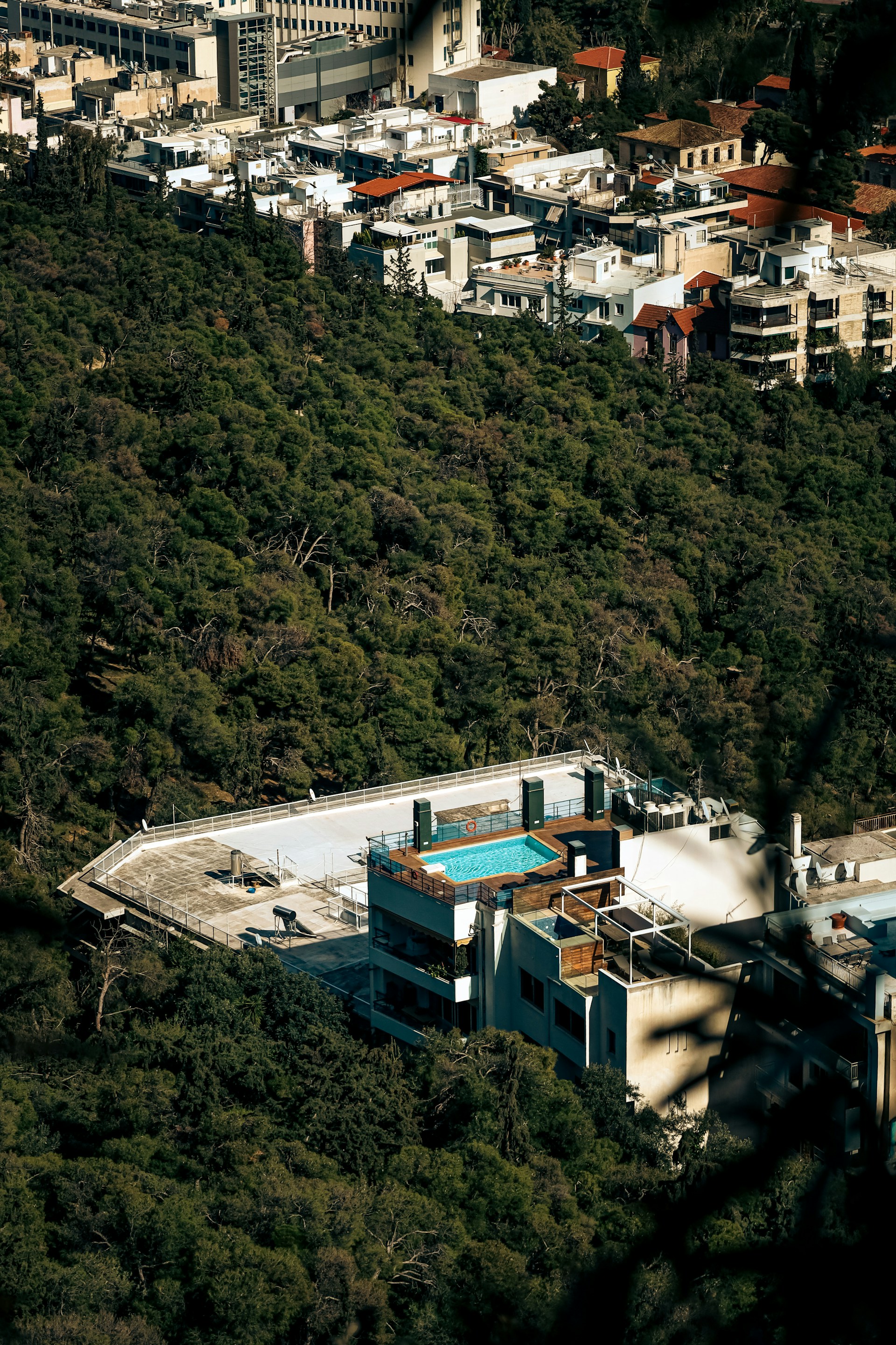 an aerial view of a building with a swimming pool