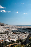 An aerial view of Kigali’s modern skyline under a clear blue sky.