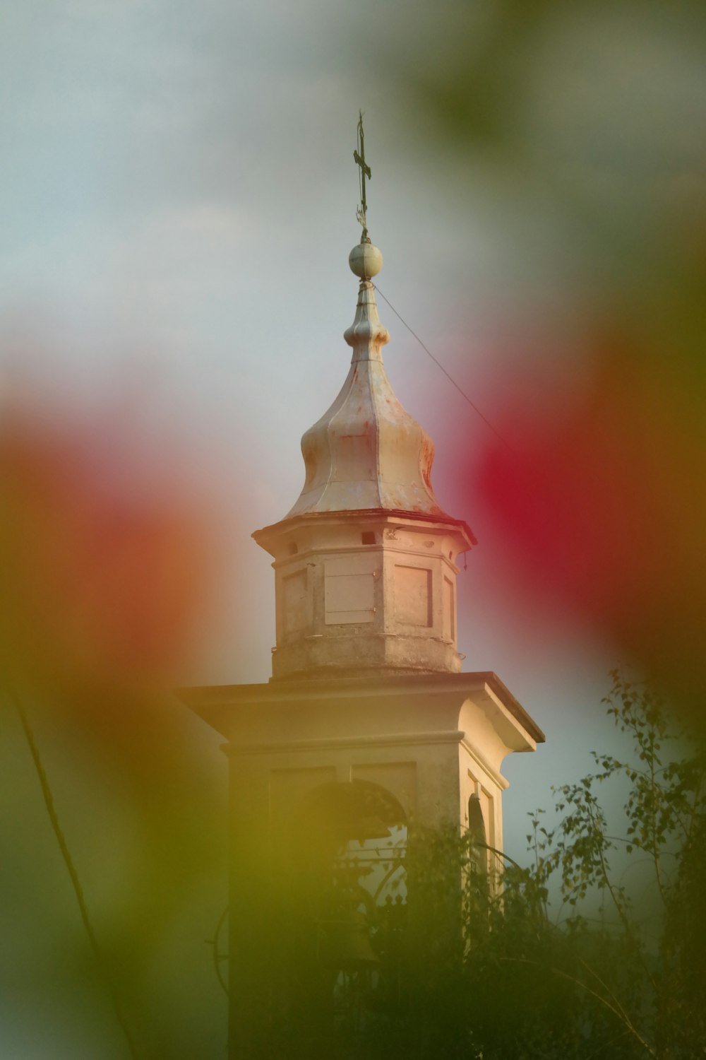 a clock tower with a weather vane on top of it