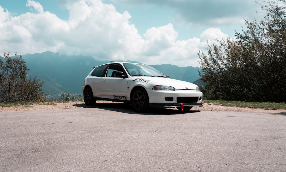 a white car parked on the side of a road