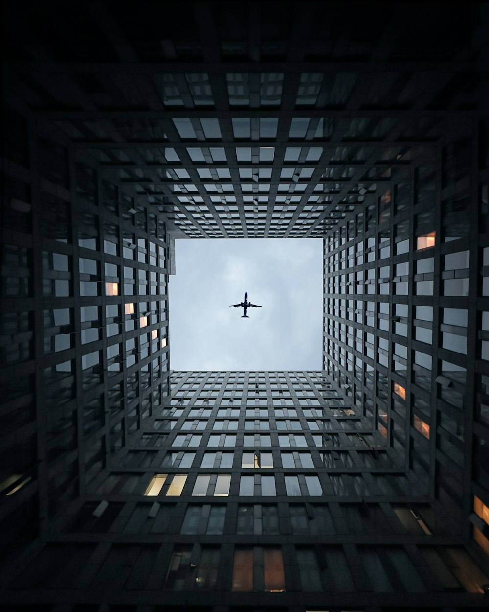 an airplane flying through a very tall building