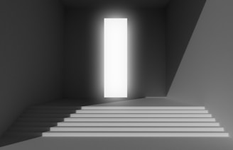 a stairway leading to a bright light in a dark room