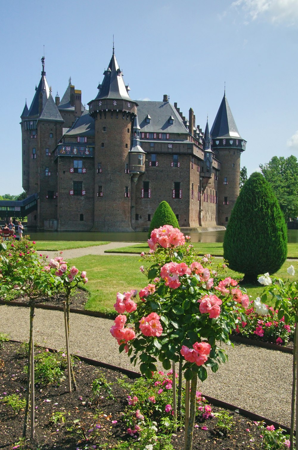 a large castle with a garden in front of it