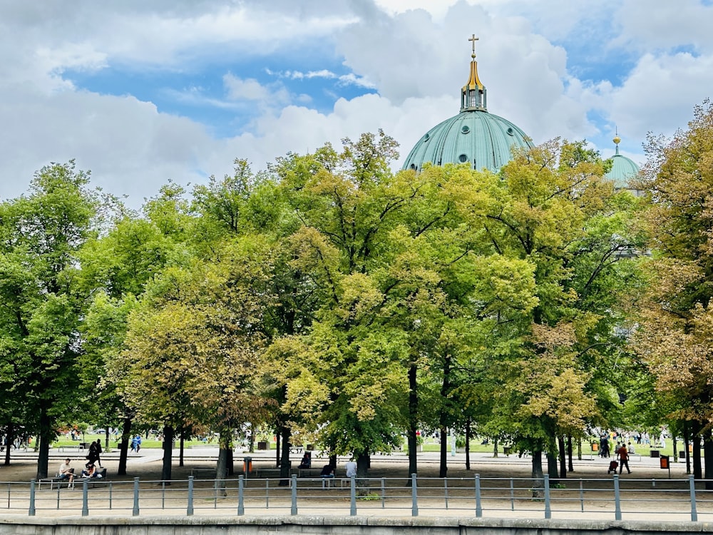 a building with a dome on top of it surrounded by trees