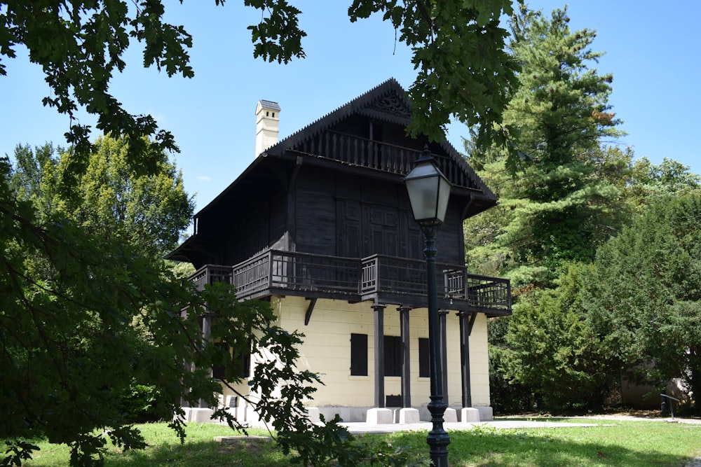 a black and white house with a lamp post