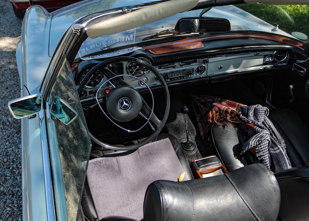 the interior of a car with a surfboard on the dashboard
