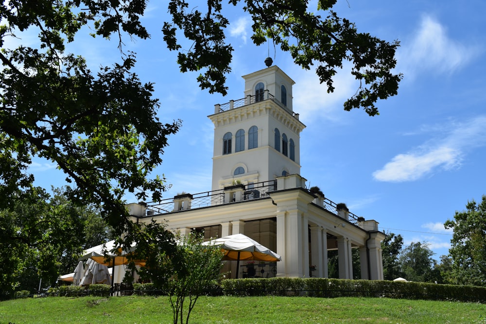 a large white building with a clock tower