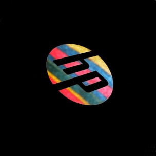 A logo with stylized letters 'hp' set against a colorful, striped oval background. The vivid stripes include blue, red, green, and yellow, contrasting sharply with the black negative space forming the logo.