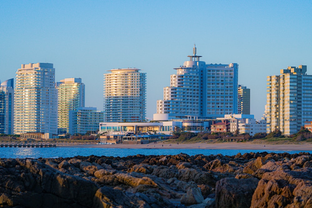 a view of a city from a rocky shore