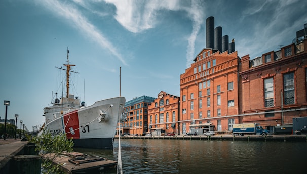 a large boat sitting in the water next to a building