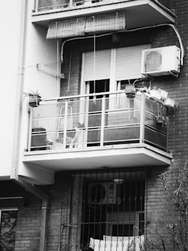 Wide shot of a balcony with bamboo blinds and pigeon net installed.