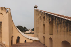 an old building with a walkway between two buildings