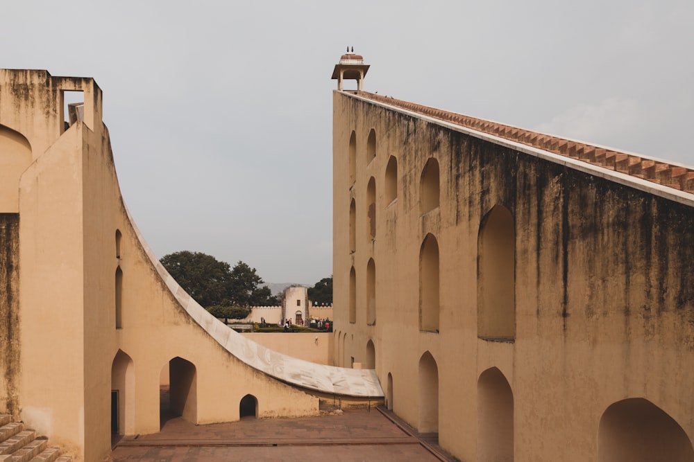 an old building with a walkway between two buildings