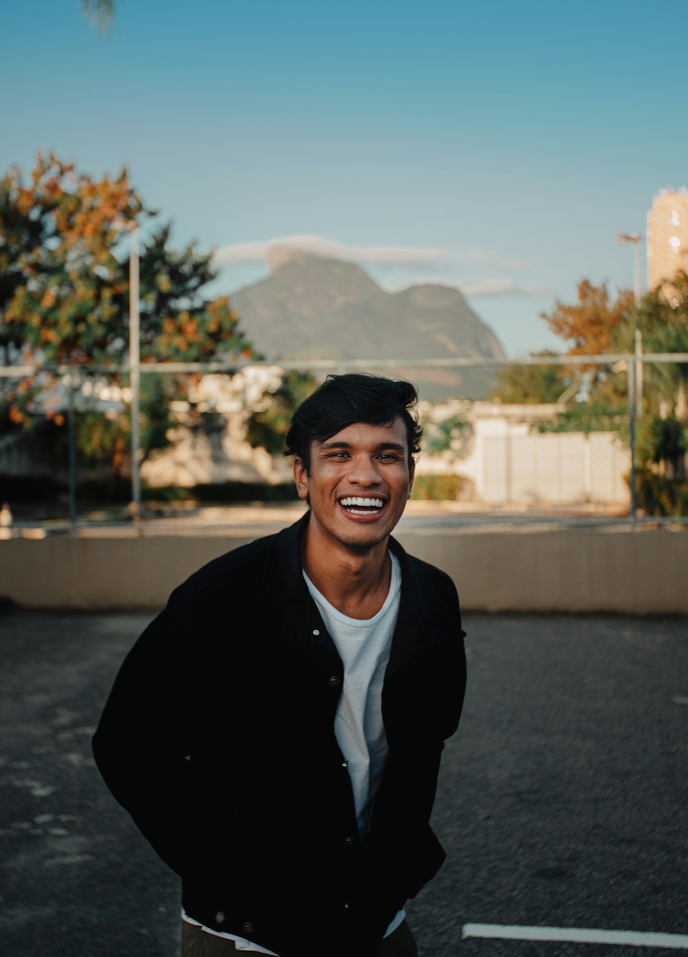 a man standing in the middle of a parking lot