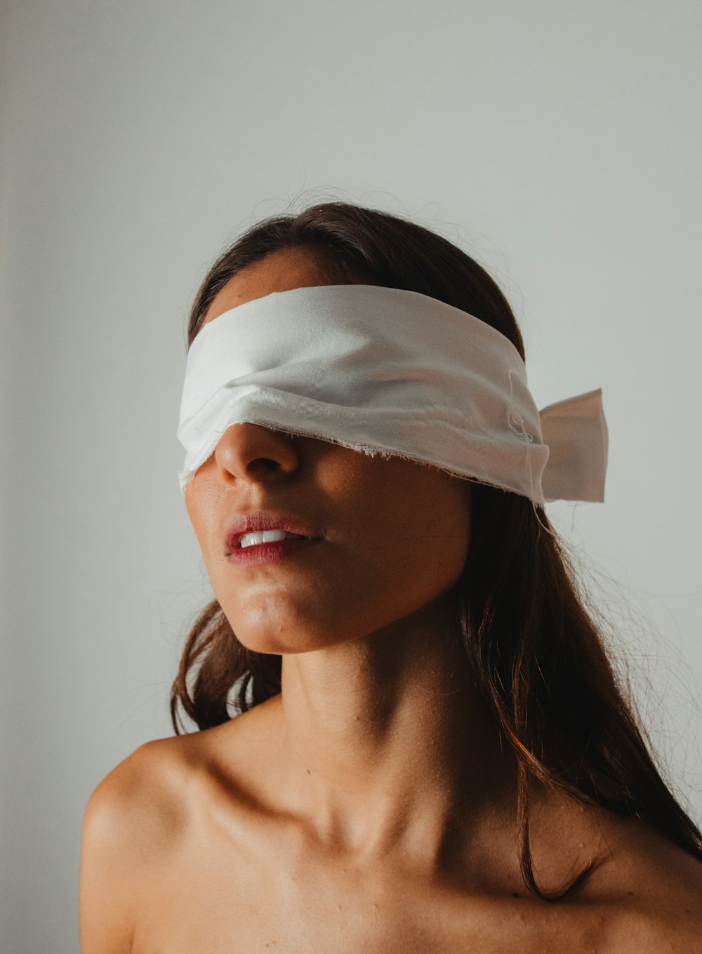 a woman with a blindfold on her head