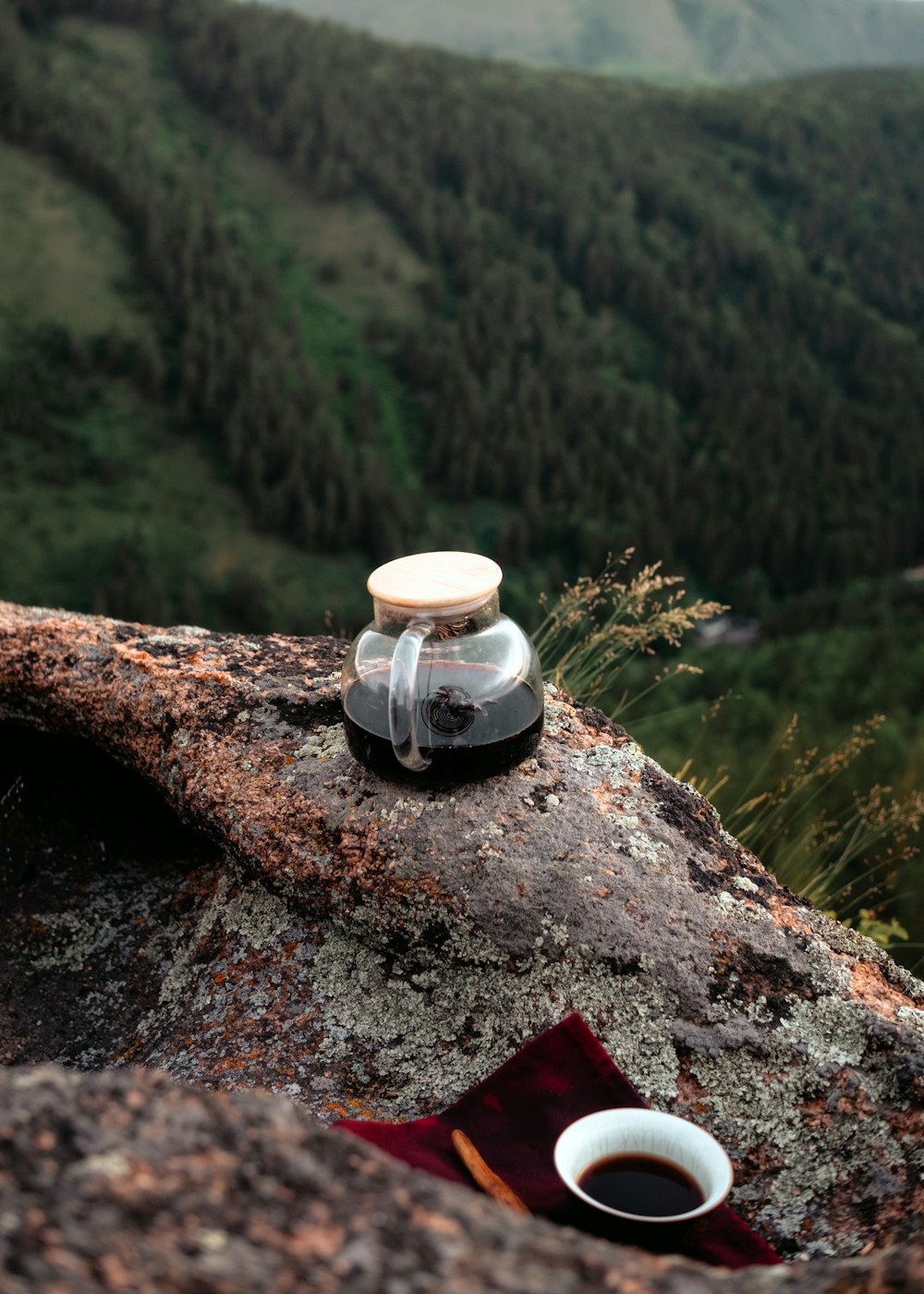 a cup of coffee sitting on top of a rock