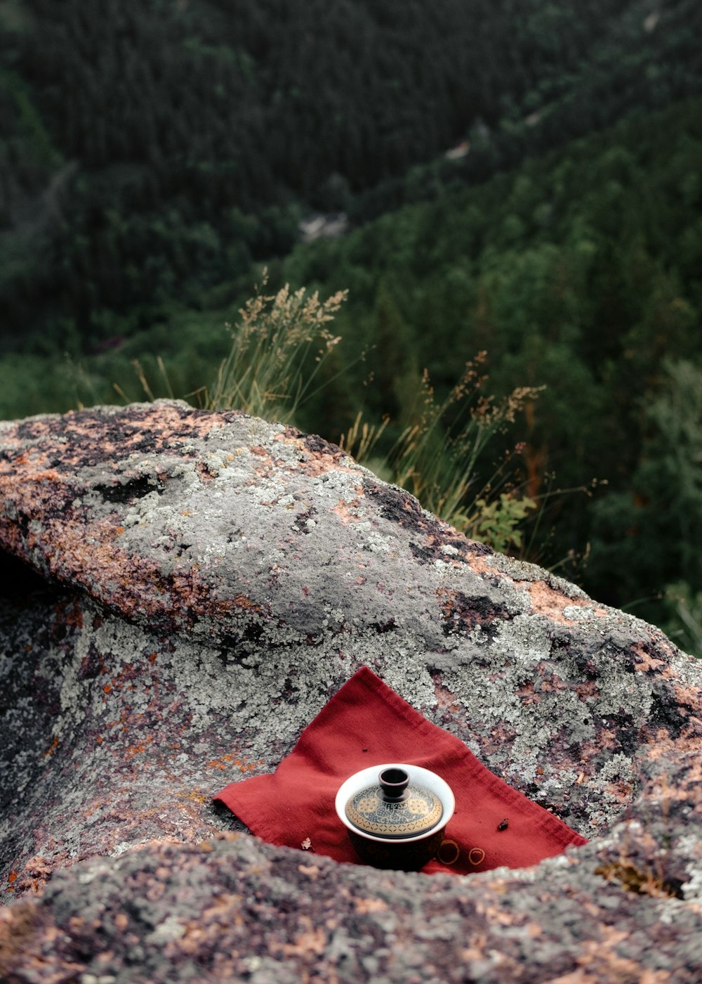 a cup of coffee sitting on top of a rock