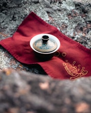 a tea pot sitting on top of a red napkin