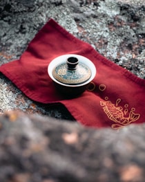 a tea pot sitting on top of a red napkin