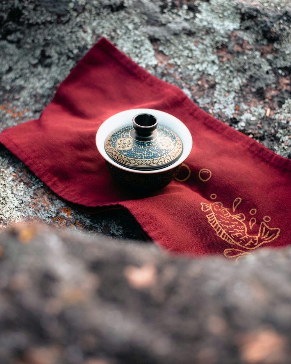 a tea pot sitting on top of a red napkin